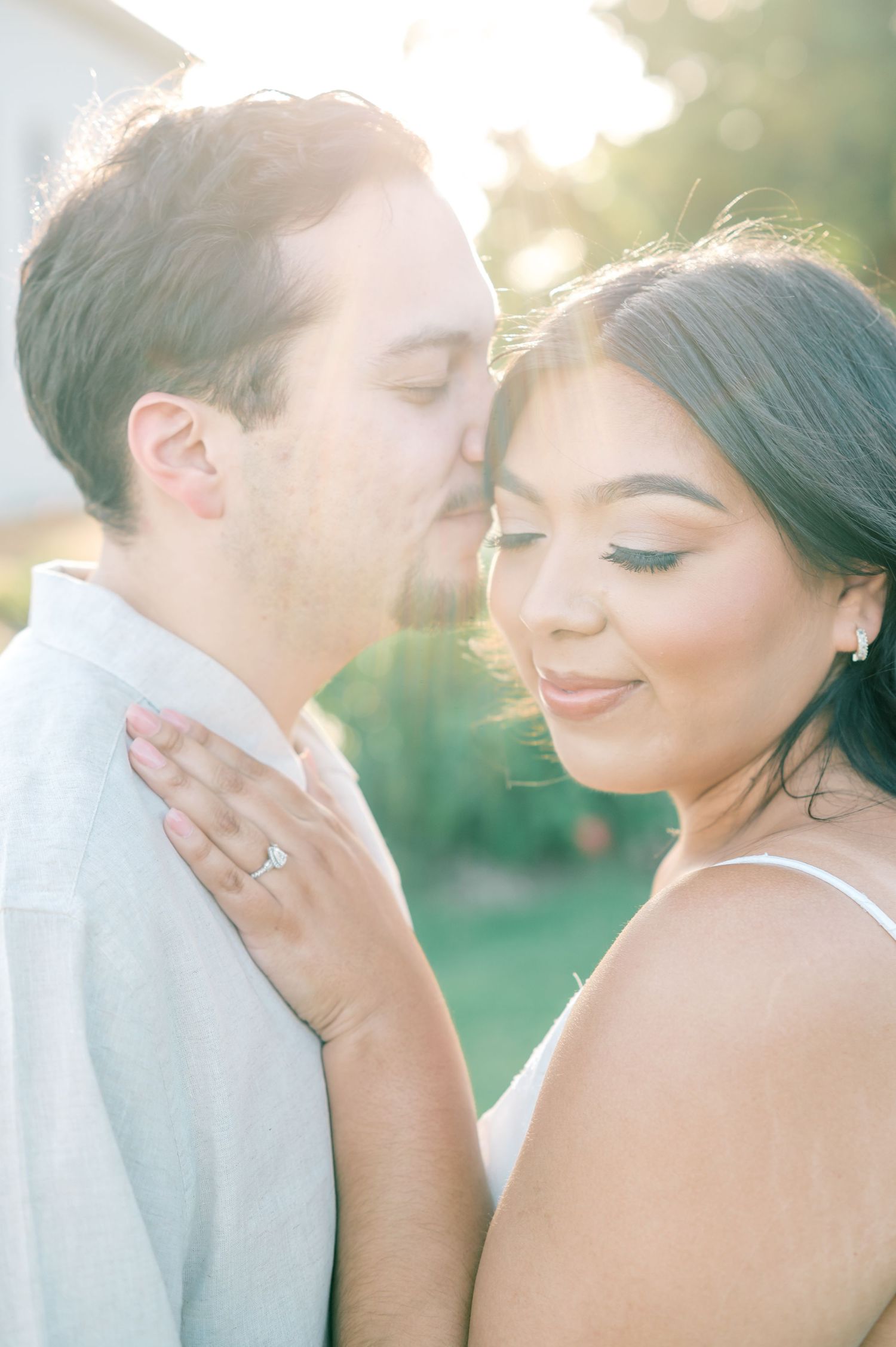Dreamy sunlit wedding portraits capturing intimate moments between newlyweds.