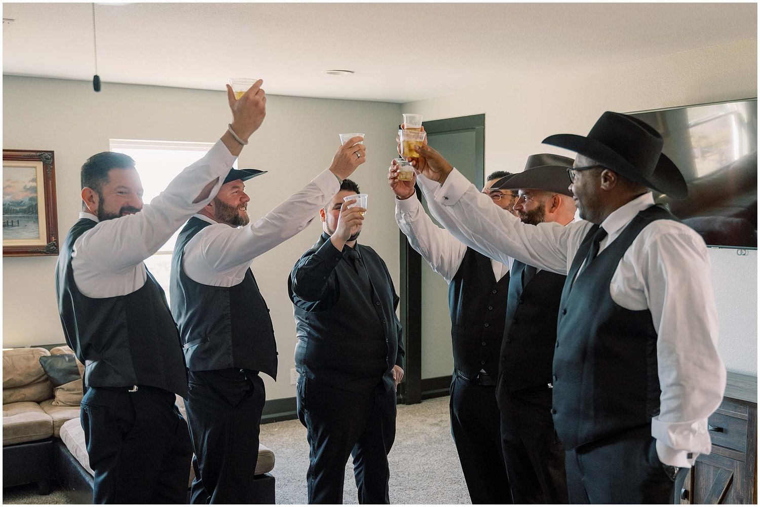 A sequence of wedding party members dancing and celebrating together in a line formation.