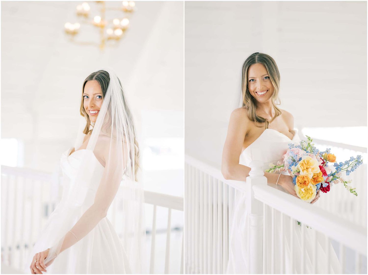 Bride in white gown and veil smiles softly, holding colorful bouquet on bright white staircase.