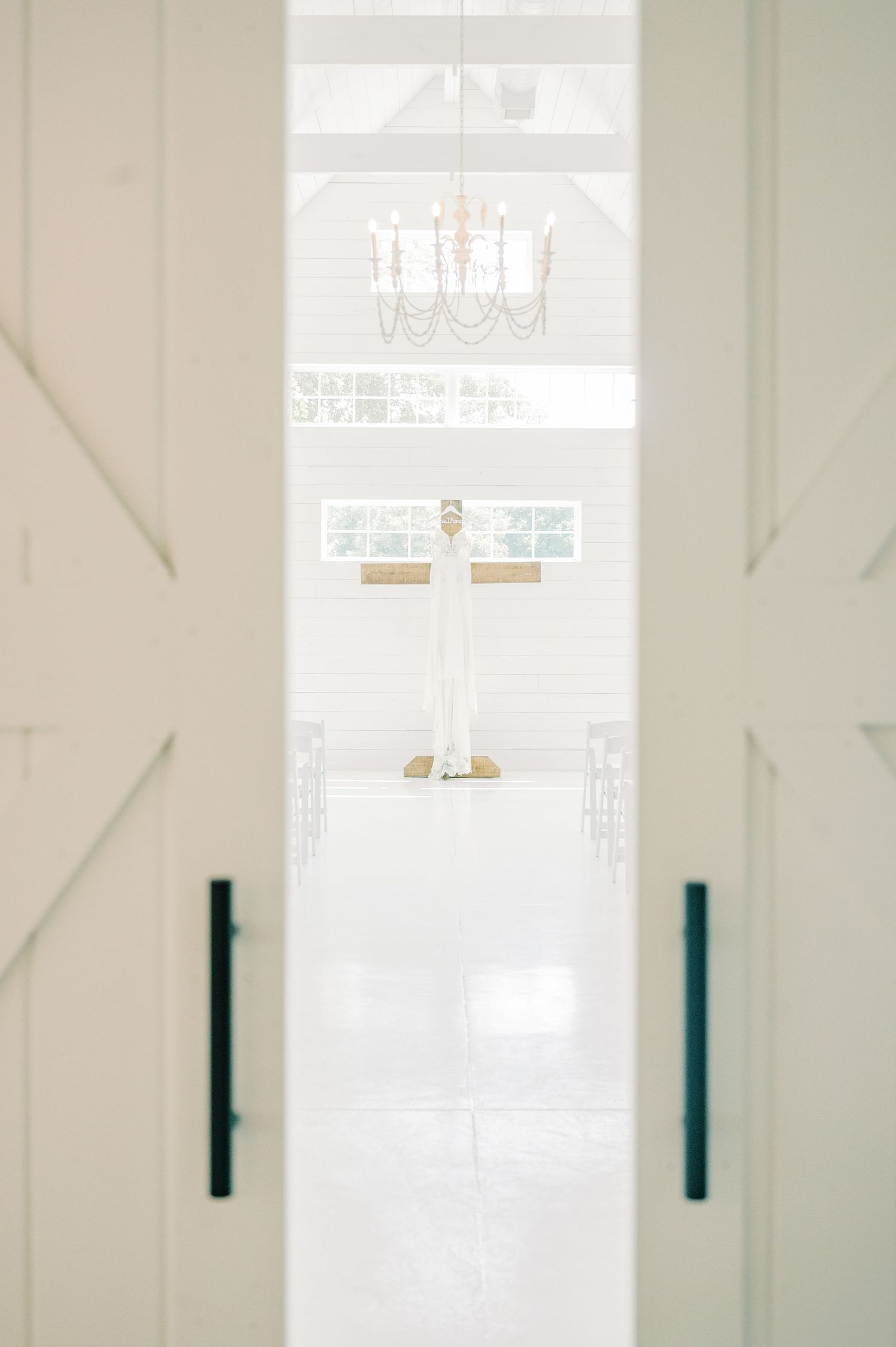 Modern white interior with minimalist design and large windows.