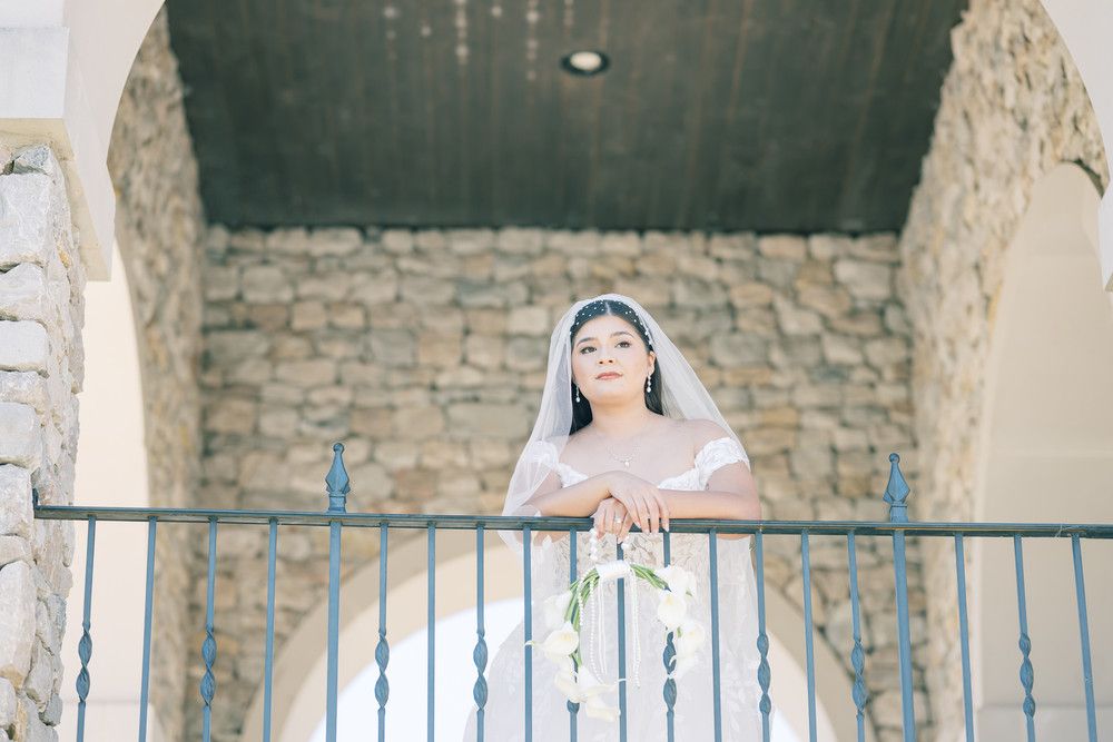 Stone archways and columns create a romantic architectural backdrop for bridal photography.