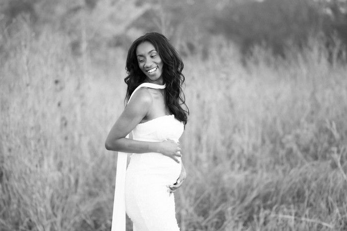 Artistic black and white maternity photography series in an outdoor setting.