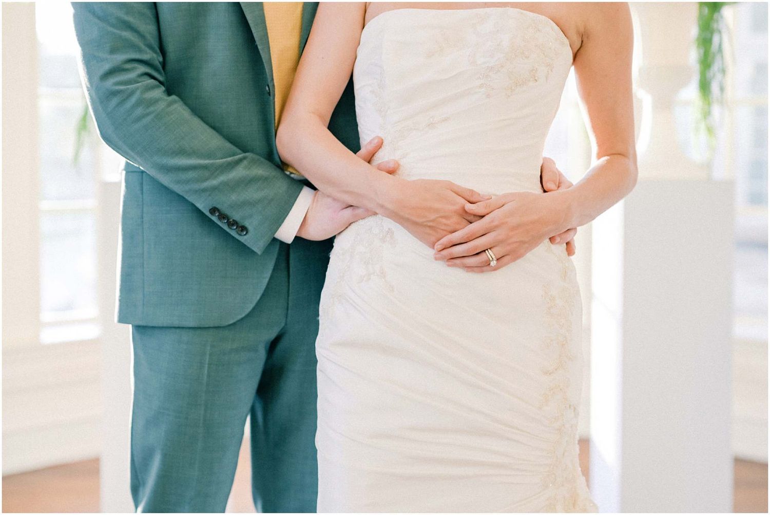Elegant wedding couple shares intimate moments in a bright indoor venue with classic decor.