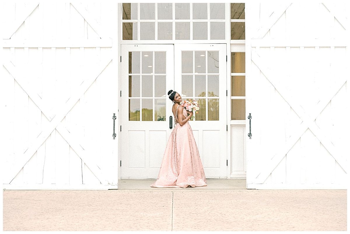 Black bride in a shimmering rose-gold sequined wedding gown with an open back and pearl draping at The White Sparrow Barn.