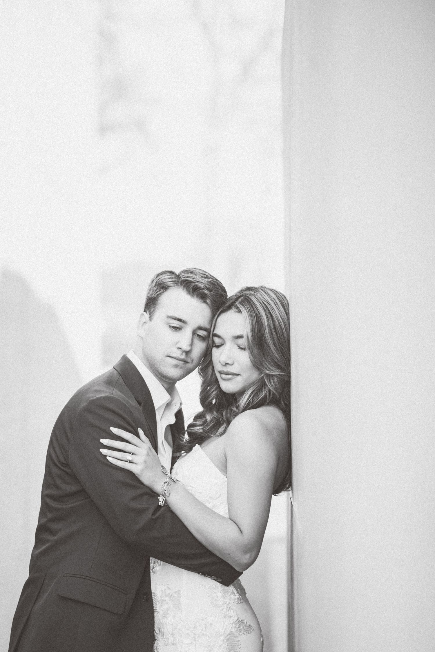A romantic black and white wedding photo collage showing tender moments between a bride and groom against a light background.