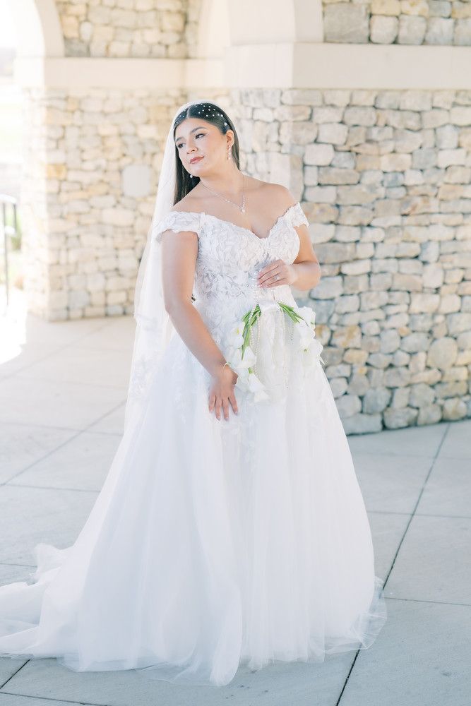 Ethereal bridal portraits showing flowing white dress details against an arched stone colonnade.