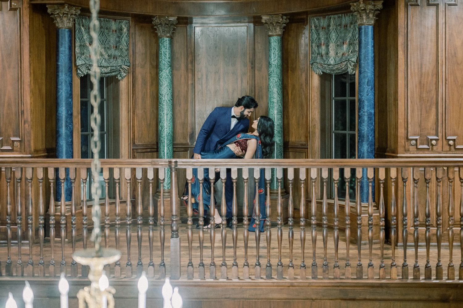 Elegant wood-paneled interior with ornate balcony and classic architectural details.