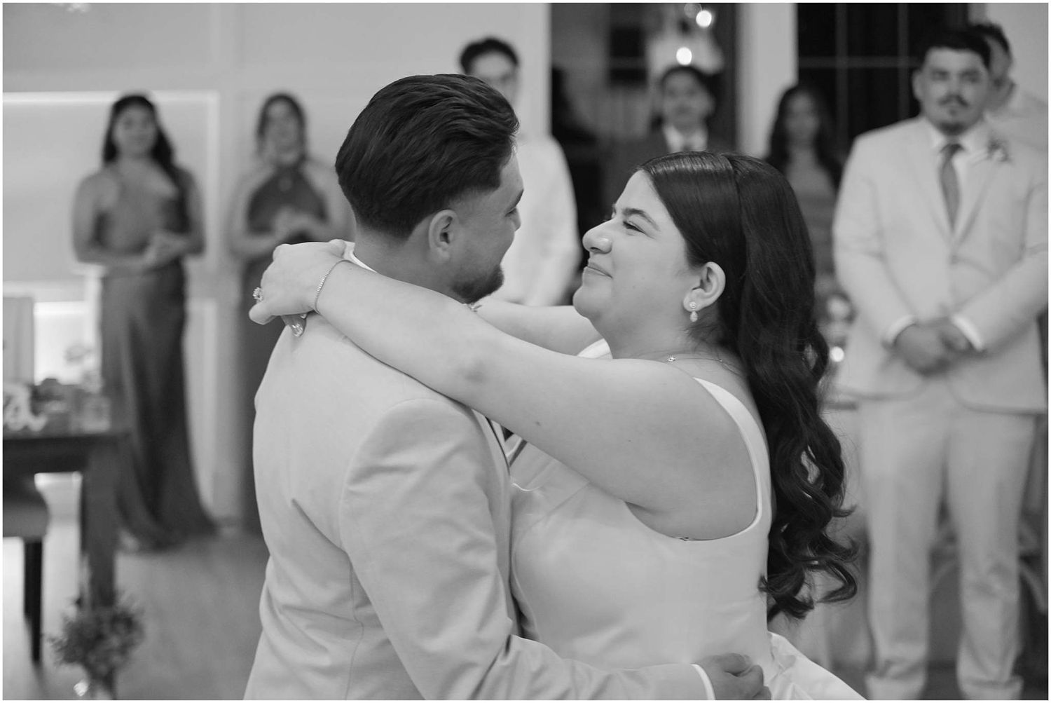 Romantic dance moments captured during a wedding reception with soft lighting.