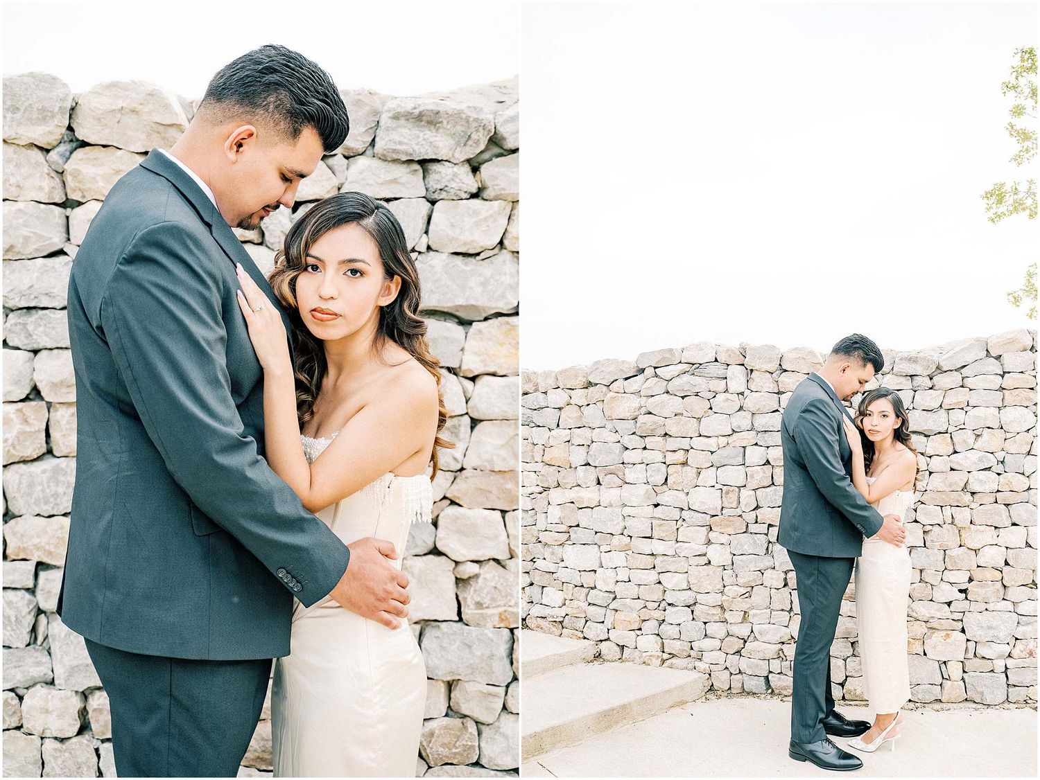 A romantic couple embraces against a rustic stone wall backdrop in an elegant outdoor wedding photoshoot.