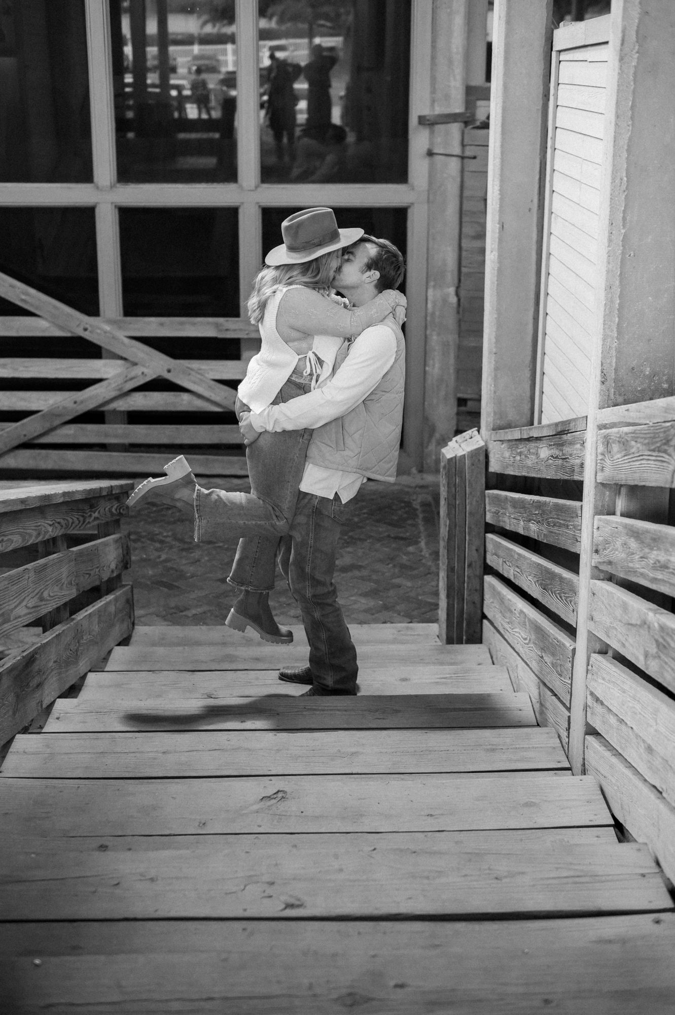 Sequence of black and white photos showing someone falling off a wooden porch or deck.