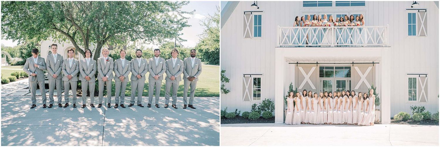 Groomsmen in gray suits pose outdoors beside bridesmaids in blush pink dresses standing in front of a white barn venue.