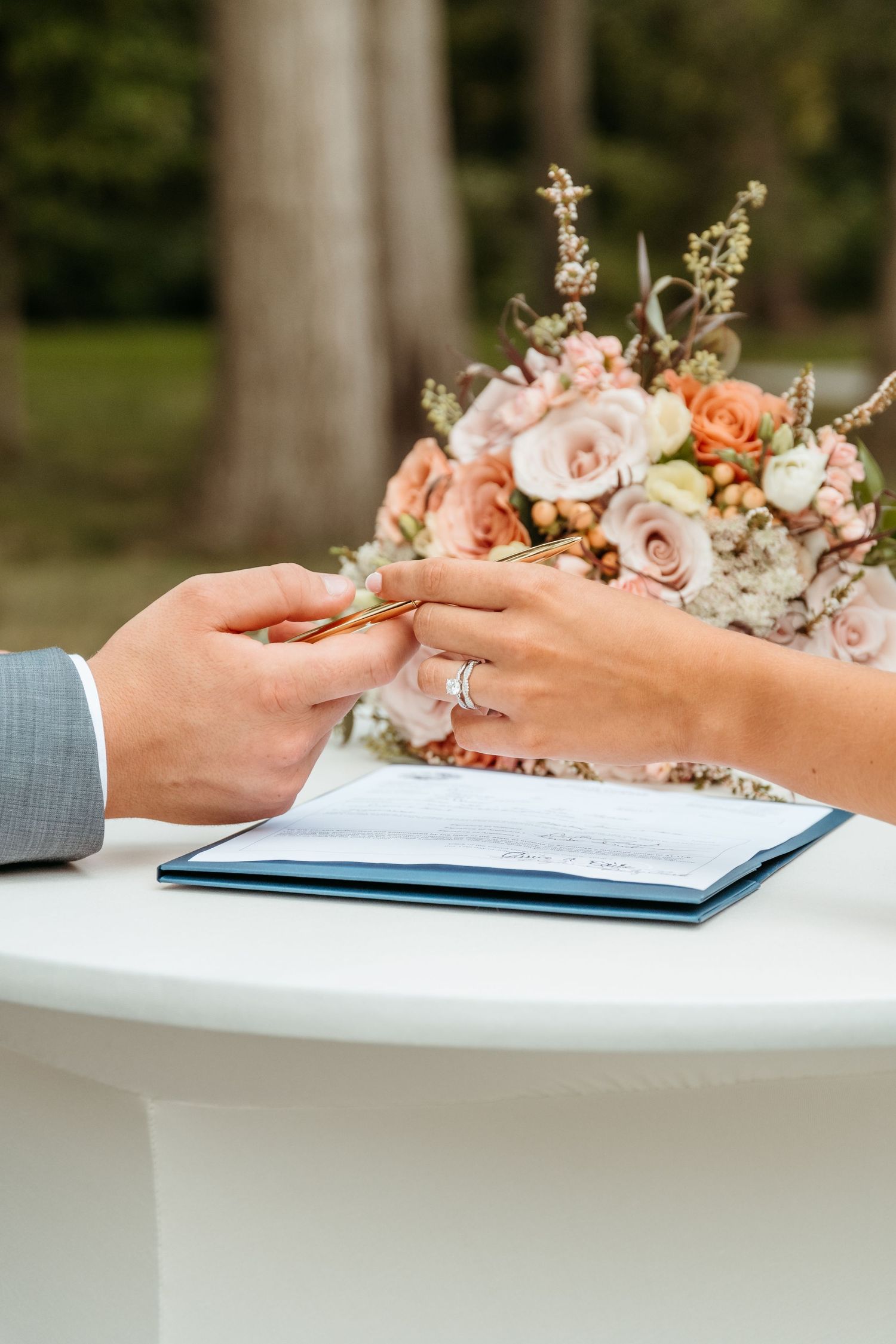 A couple signing their marriage certificate at The Wooded Knot in Tippecanoe, Indiana