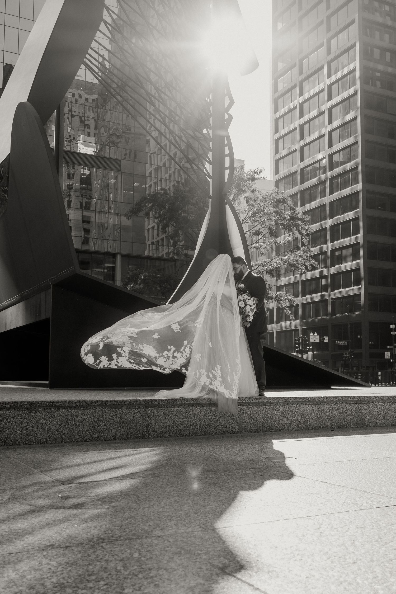 A wedding couple outside of Richard J. Daley Center in Chicago, Illinois