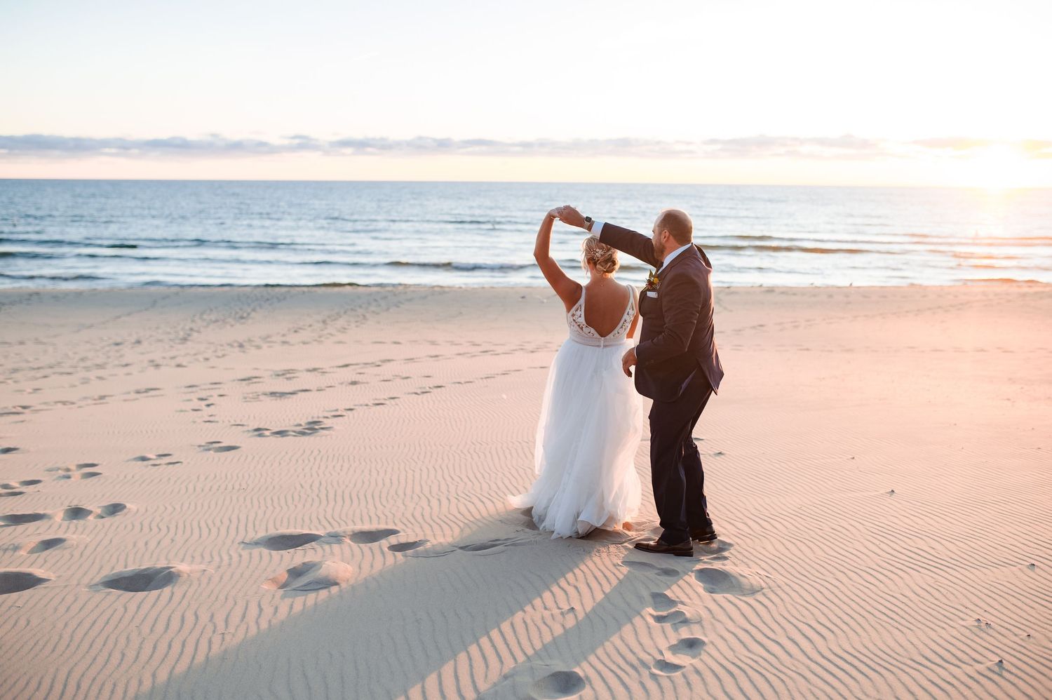 Beach wedding photography sequence at sunset with footprints in sand and golden light.