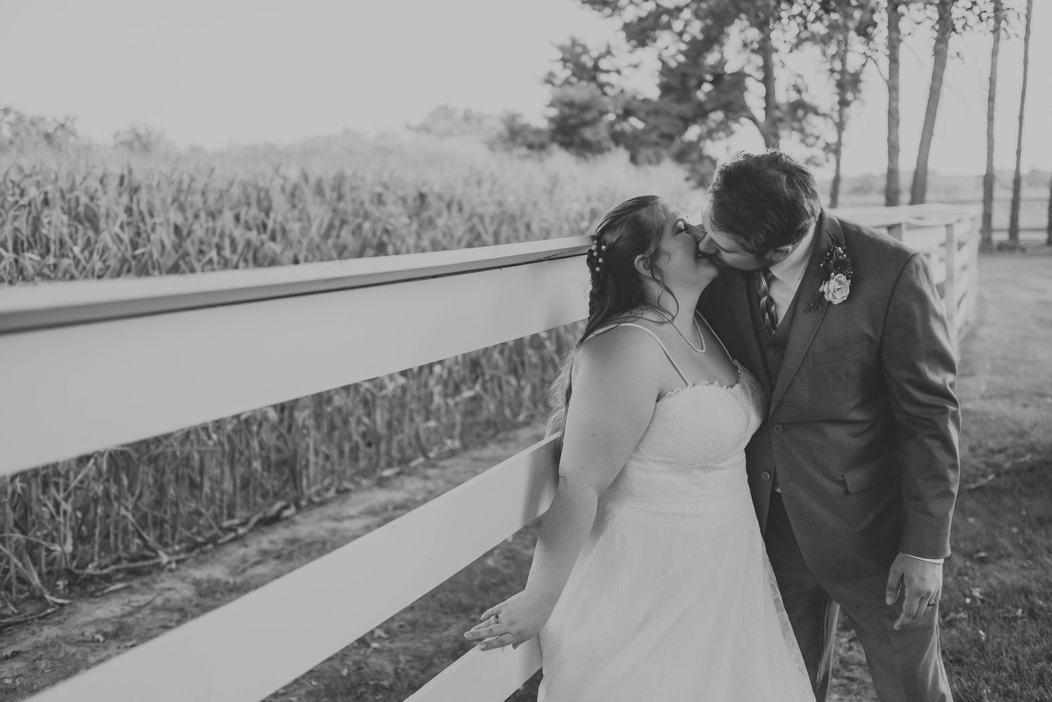 Candid wedding portraits taken in a rustic outdoor setting.