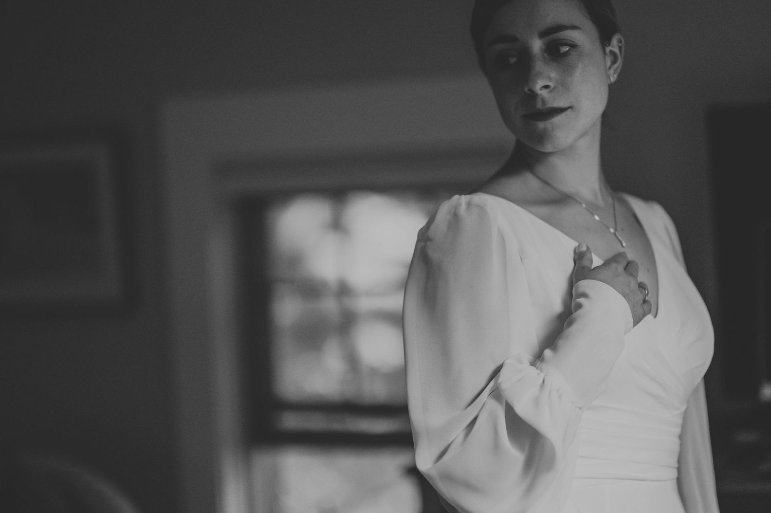 A series of elegant bridal portraits in black and white with dramatic window lighting.