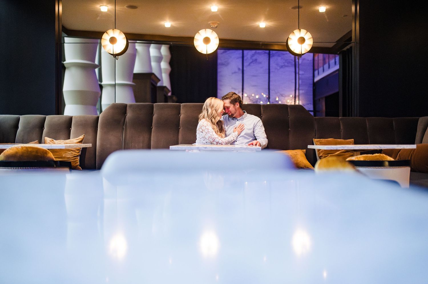 Modern restaurant interior with mood lighting and comfortable seating.