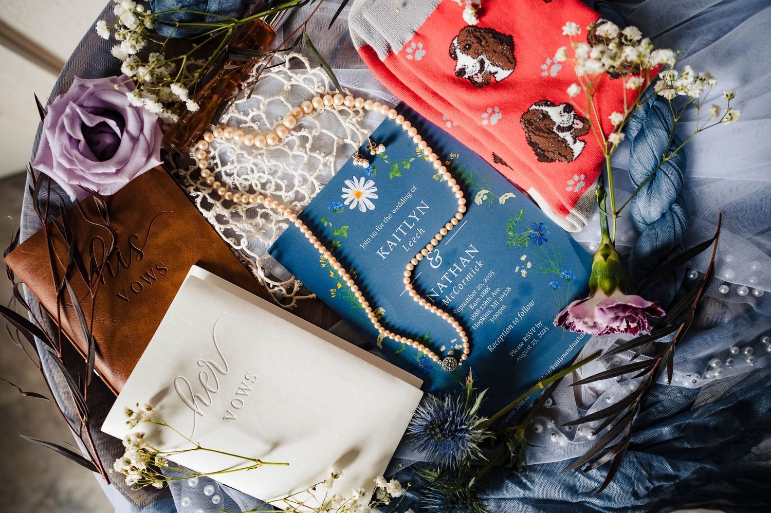 Artistically arranged wedding invitation suite with blue and coral details.