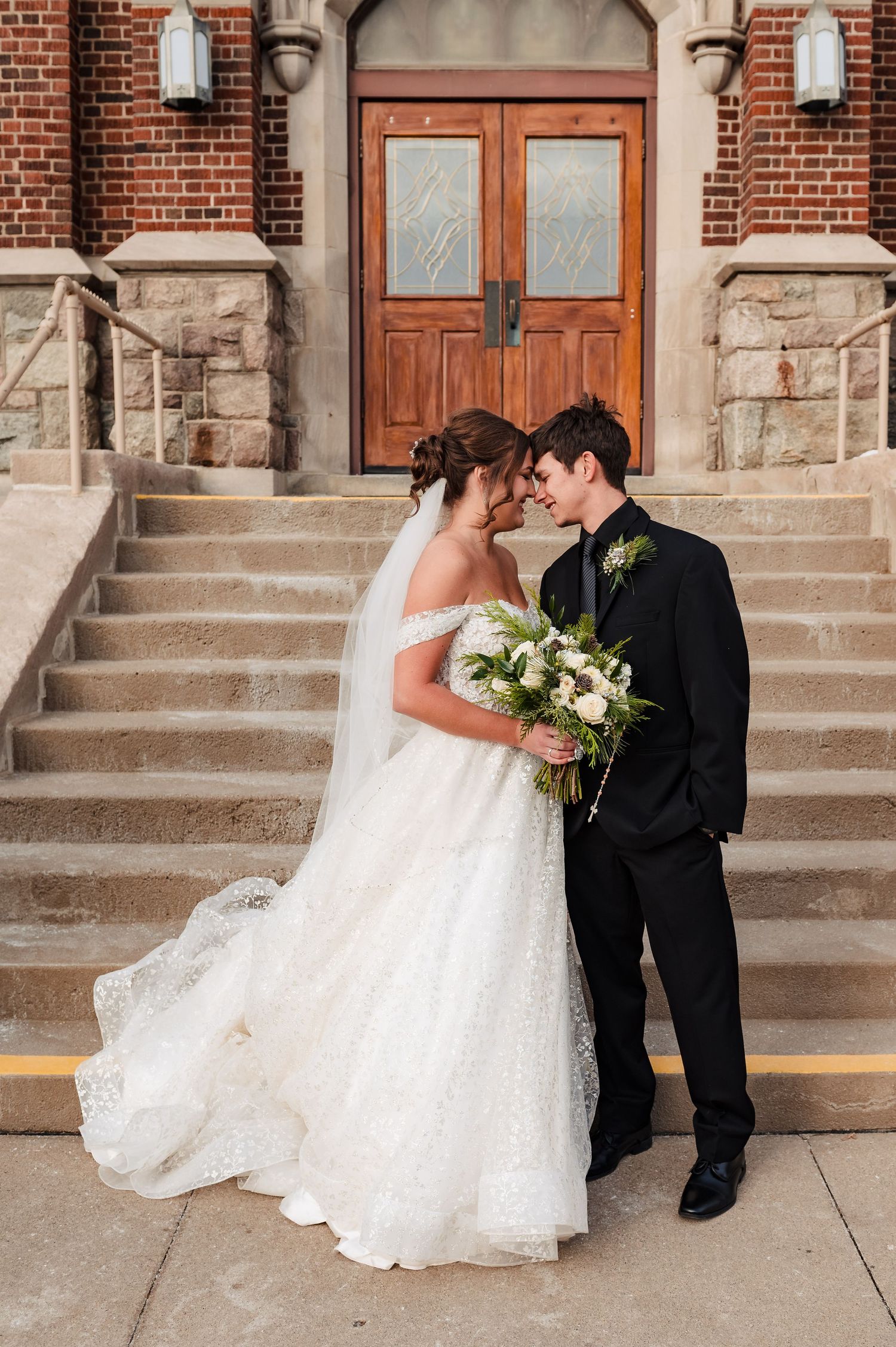 A romantic wedding photoshoot sequence on brick church steps with flowing white dress and classic black tuxedo.