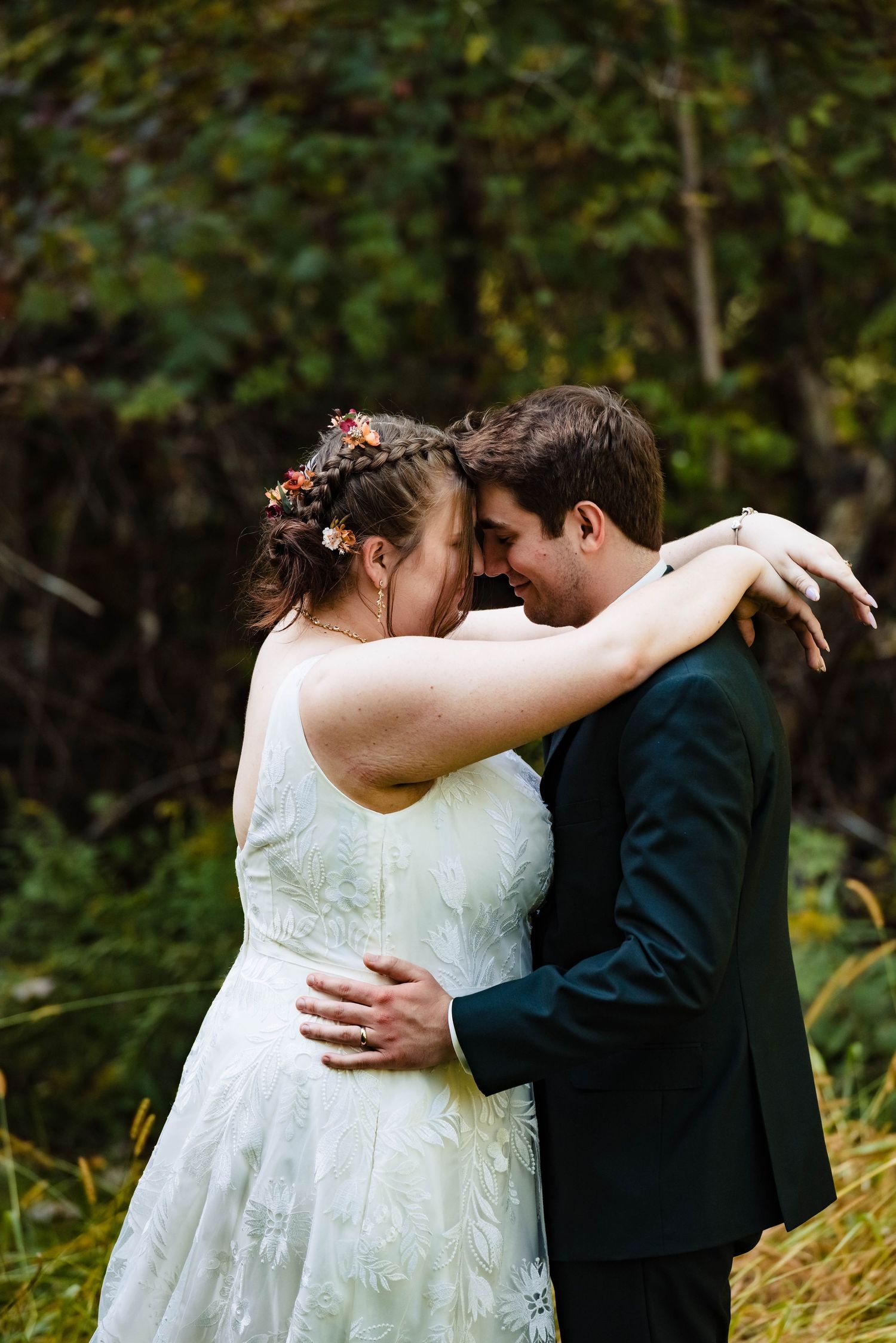 Intimate wedding couple moment captured in a lush garden setting.
