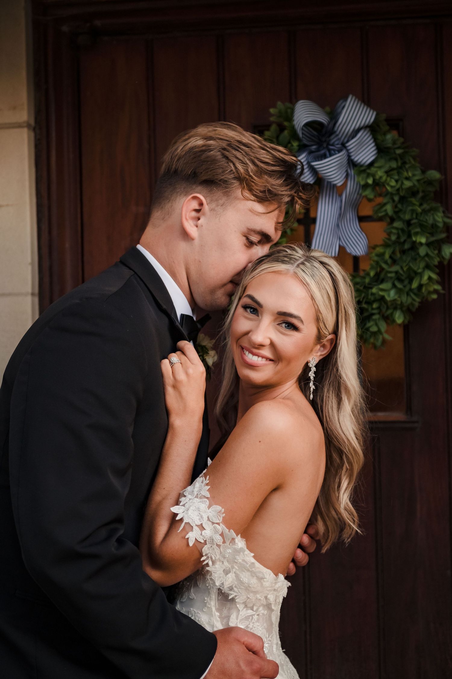 A romantic wedding couple shares intimate moments in a series of black and white portraits against a wooden door.