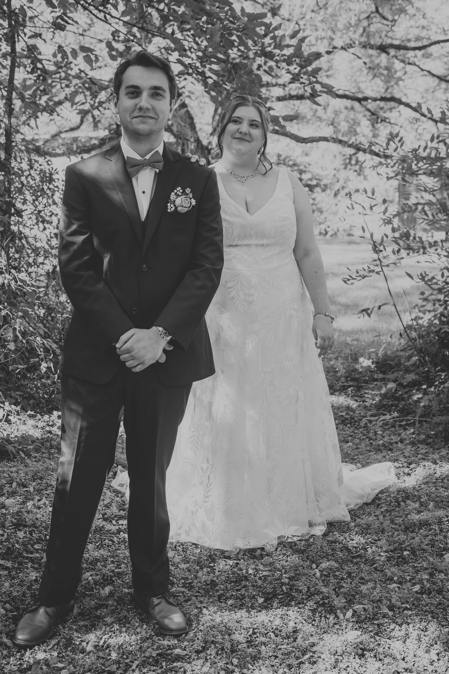 Black and white wedding portraits in a natural woodland setting.
