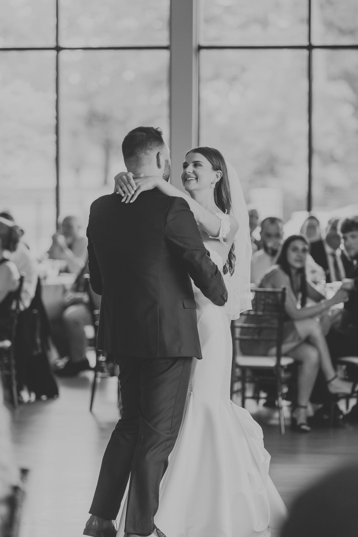 Black and white reception dance sequence showing romantic first dance moments.