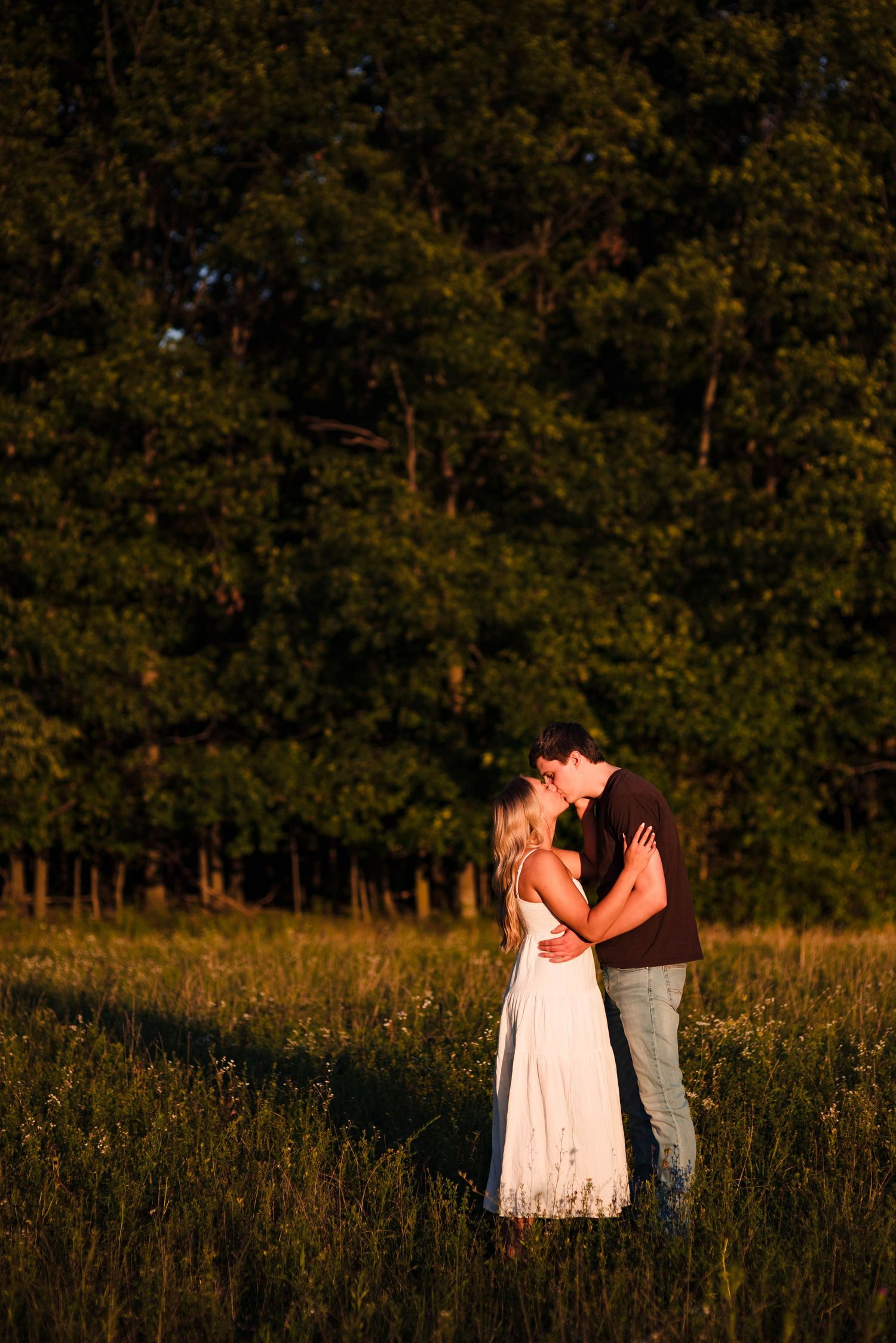 Romantic sunset embrace in a field with autumn colors.
