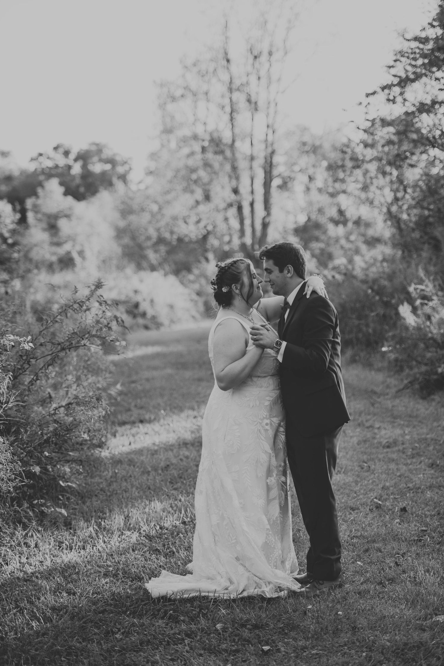 Black and white wedding portraits captured on a scenic hillside path.