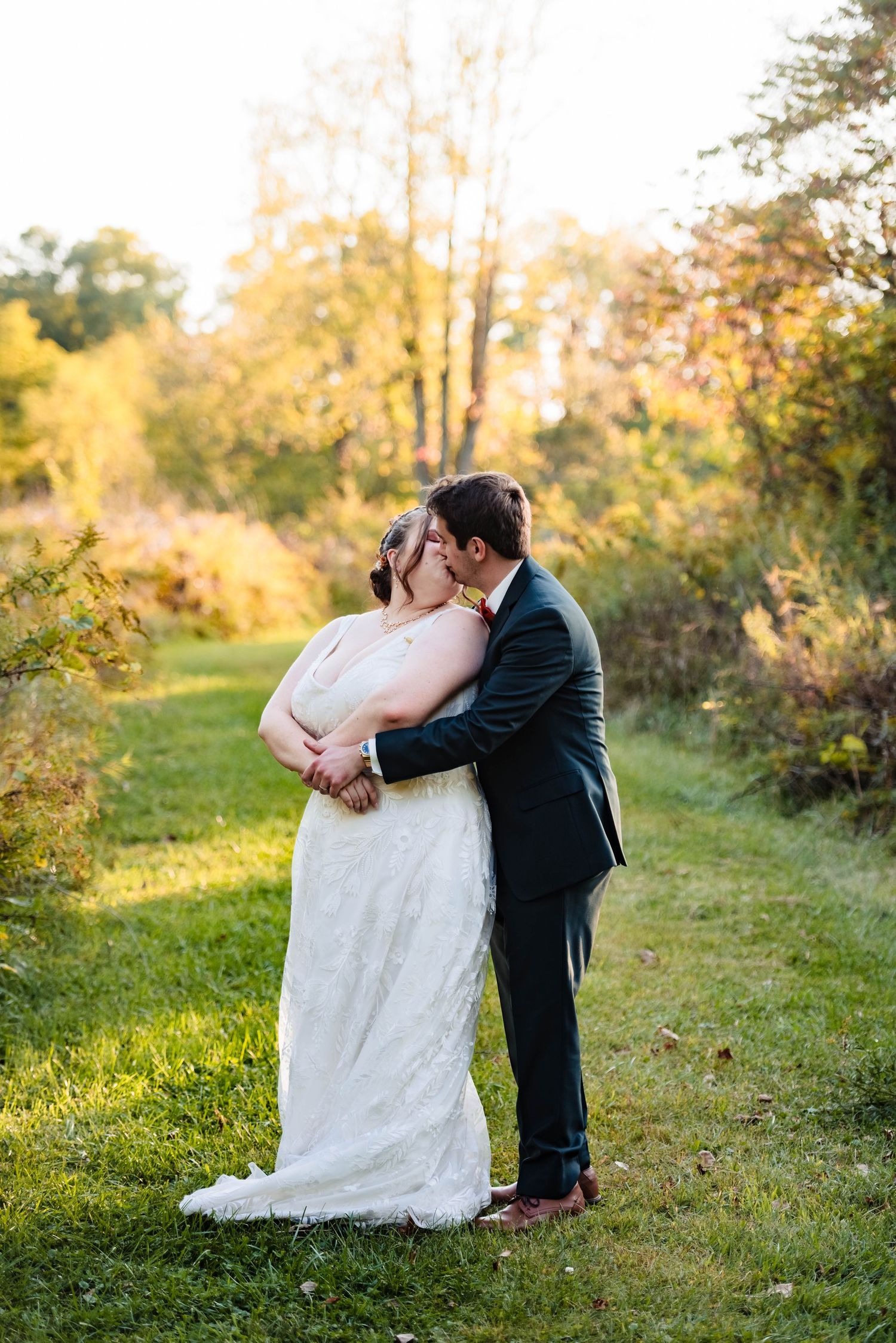 Romantic wedding portrait session in a golden sunset meadow.