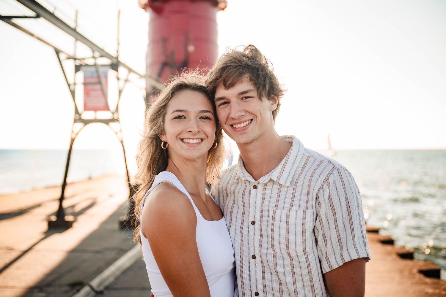 Romantic lighthouse photoshoot with bright natural lighting and coastal scenery.
