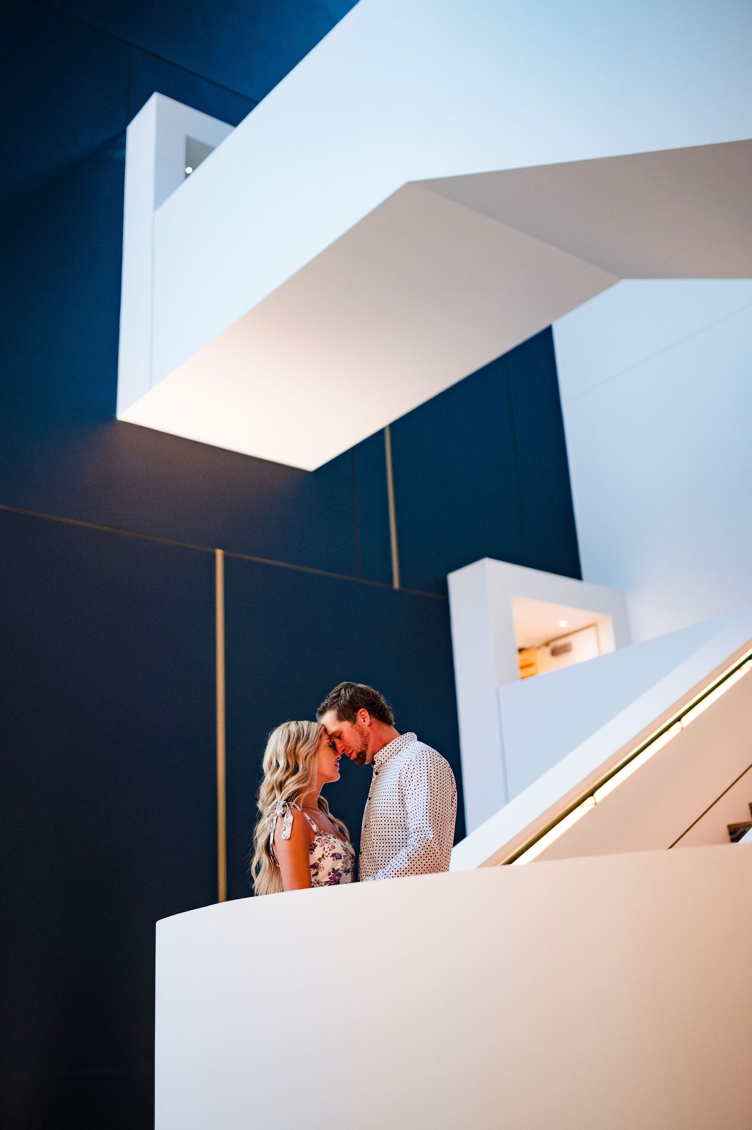 Modern architectural space with geometric white walls and dramatic shadows.