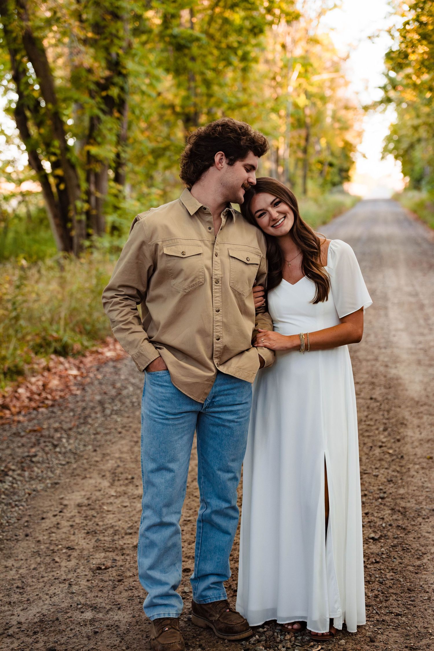 Sweet candid moments between a couple on a rustic country road.