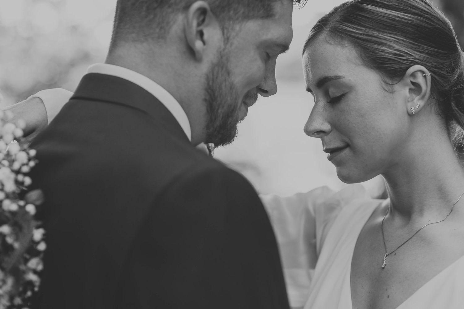 Black and white close-up wedding portraits showing intimate moments between the couple.