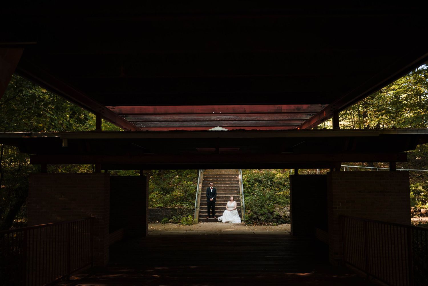 Wedding ceremony venue with dark silhouettes against bright natural lighting.