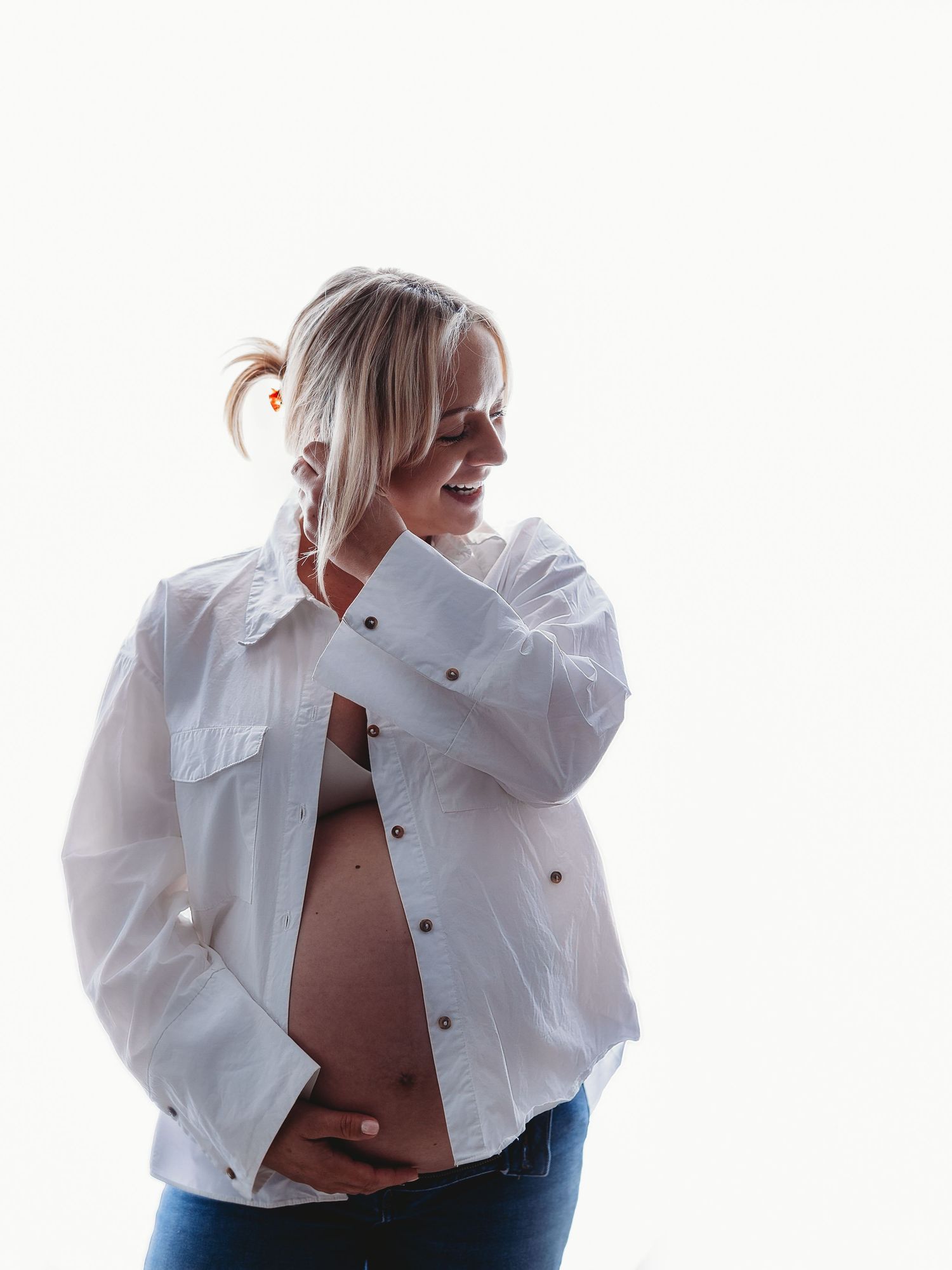 Person in white button-up shirt posing against white background in artistic fashion series.