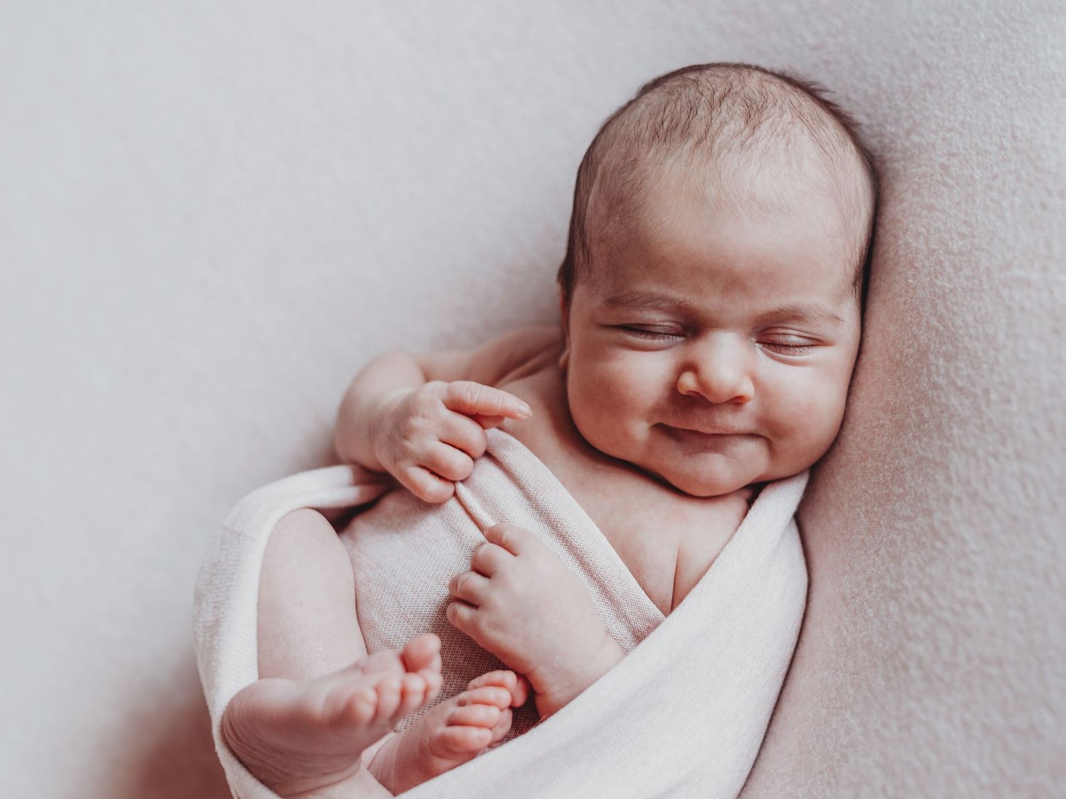 A collage of four tender newborn baby photos showing peaceful sleeping poses and gentle expressions.