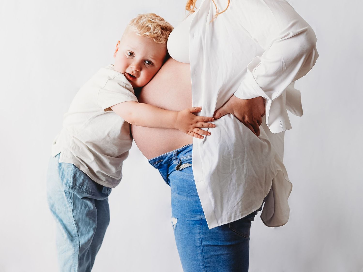 A series of tender moments captured in white clothing against a light background.
