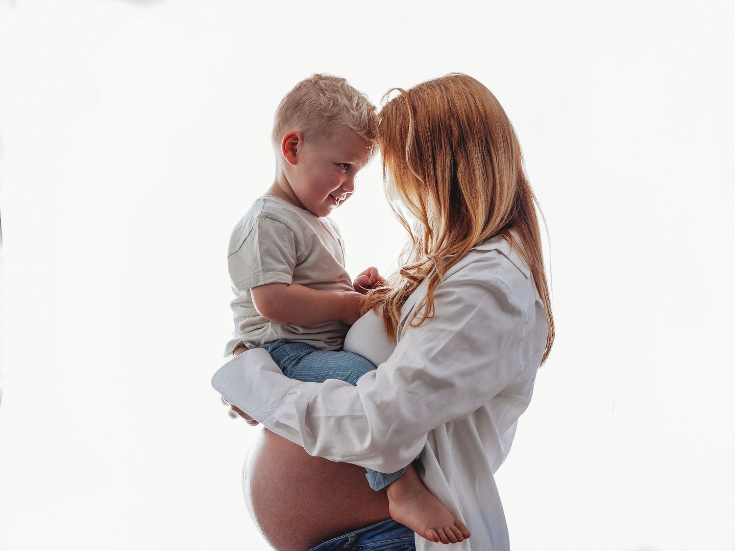 A series of tender moments between parent and baby in white clothing against a light background.