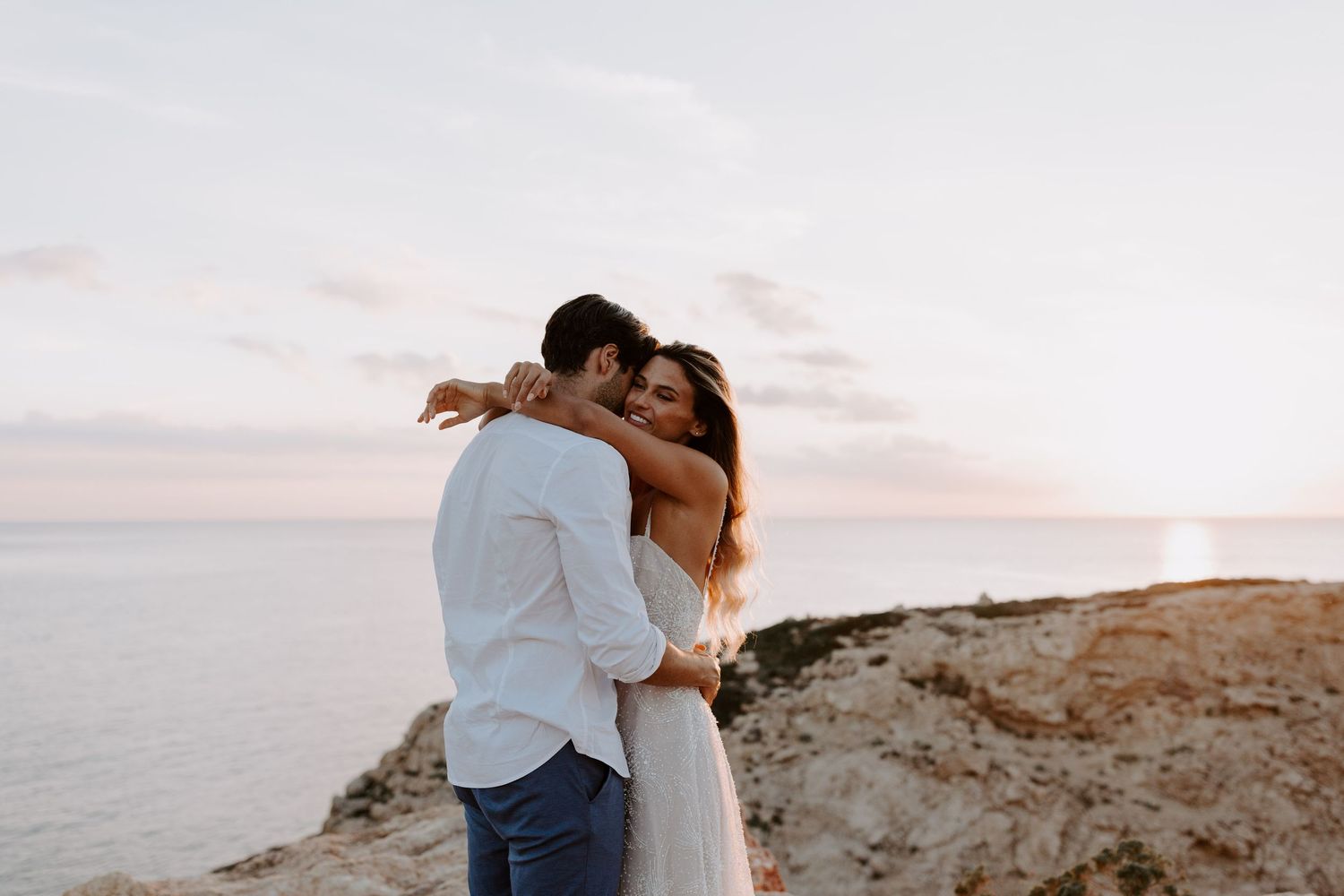 Romantic sunset moment shared on a clifftop overlooking Minorca.