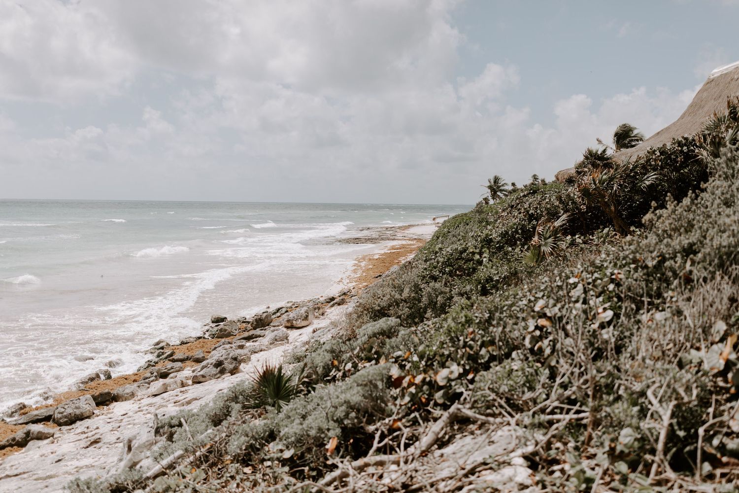 Coastal landscape with rocky cliffs overlooking a dramatic ocean shoreline.