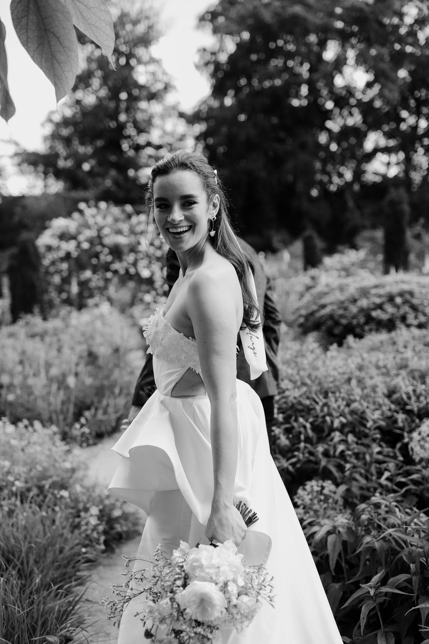 Black and white bridal portraits captured in a flourishing garden landscape.