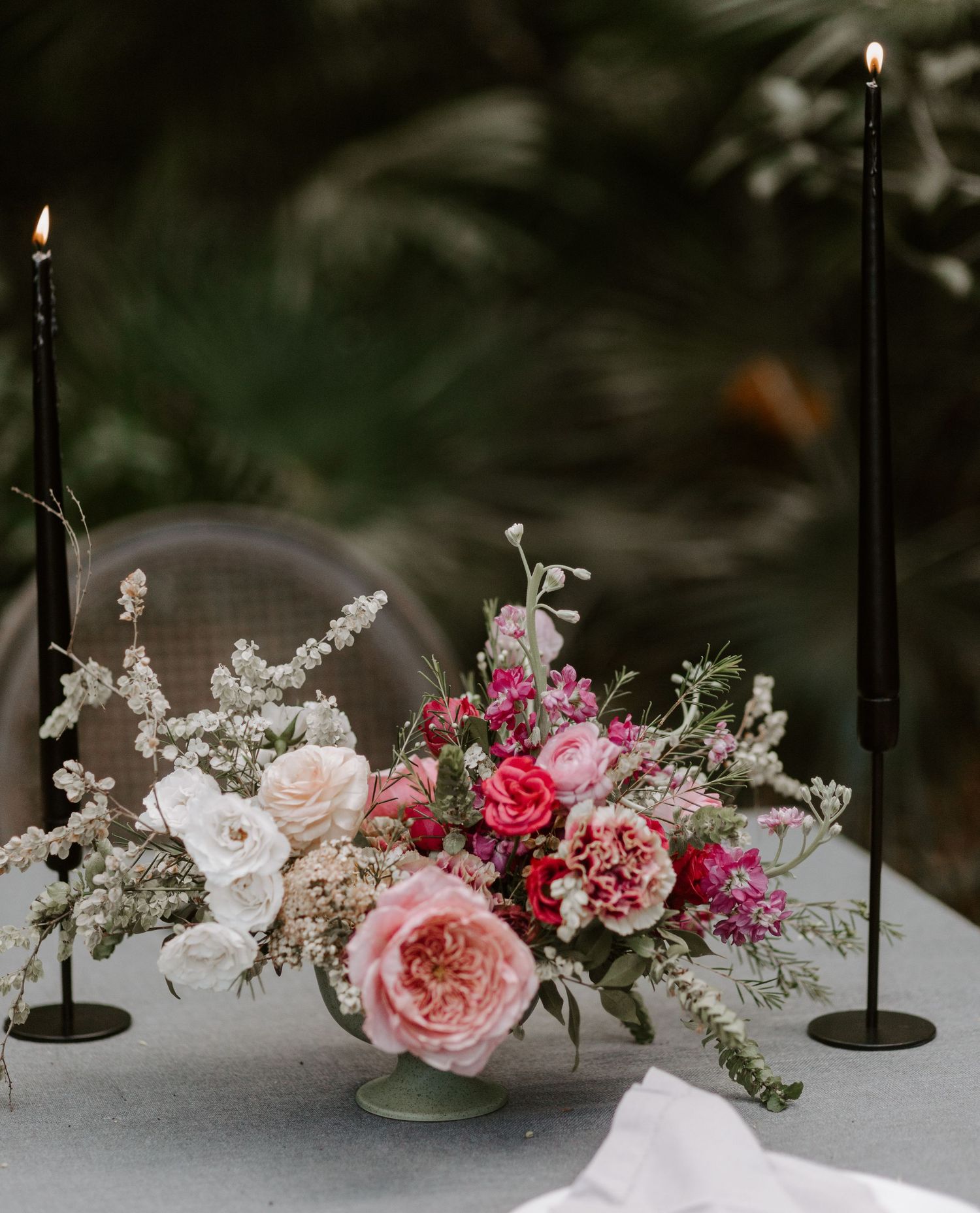 Romantic floral centerpiece with pink roses and white flowers for wedding dinner