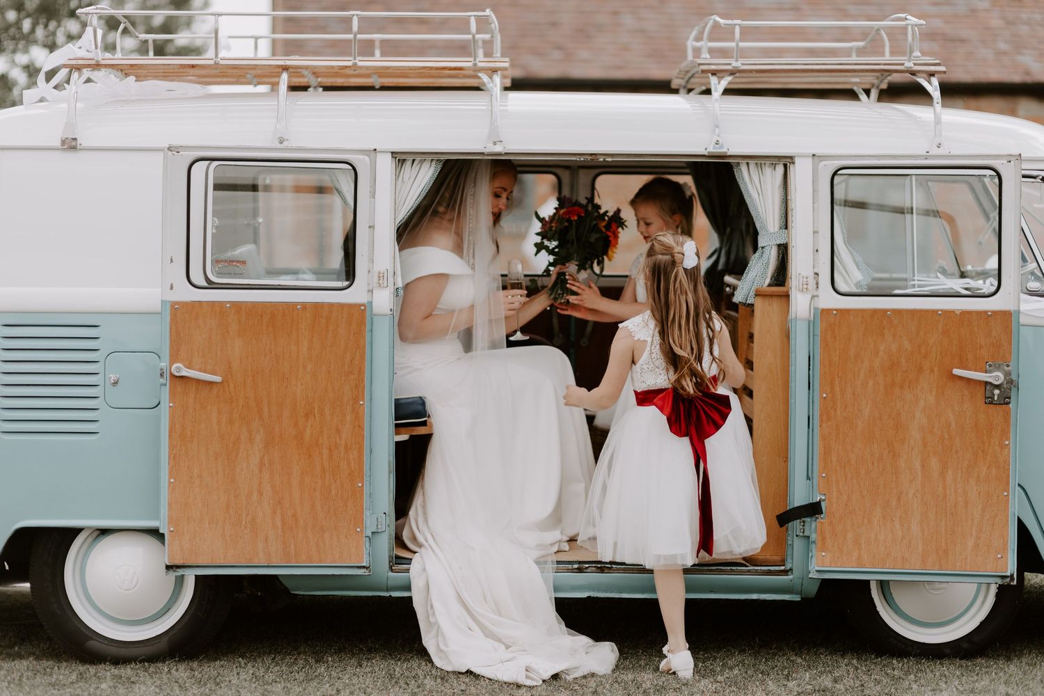 A vintage VW van decorated for a wedding with white and rustic decor.