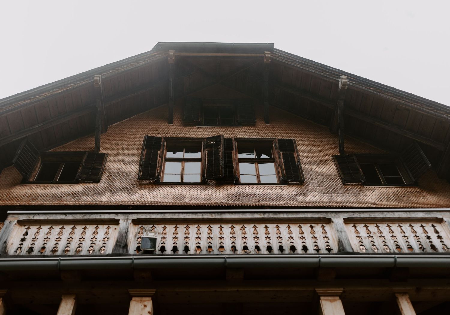 Architectural detail of a traditional wooden chalet with overhanging roof.