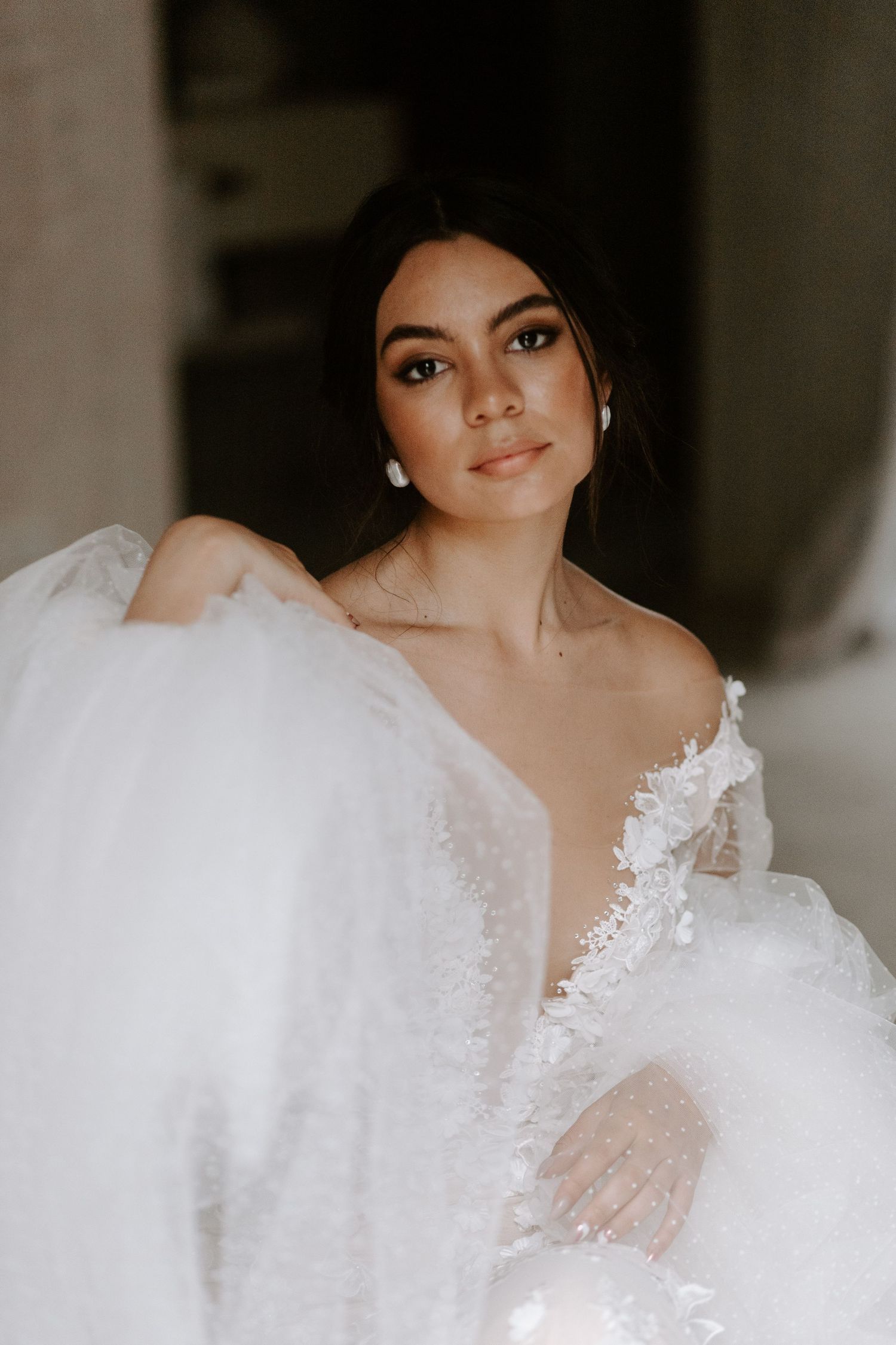 Close-up bridal portrait highlighting intricate lace details and delicate tulle.