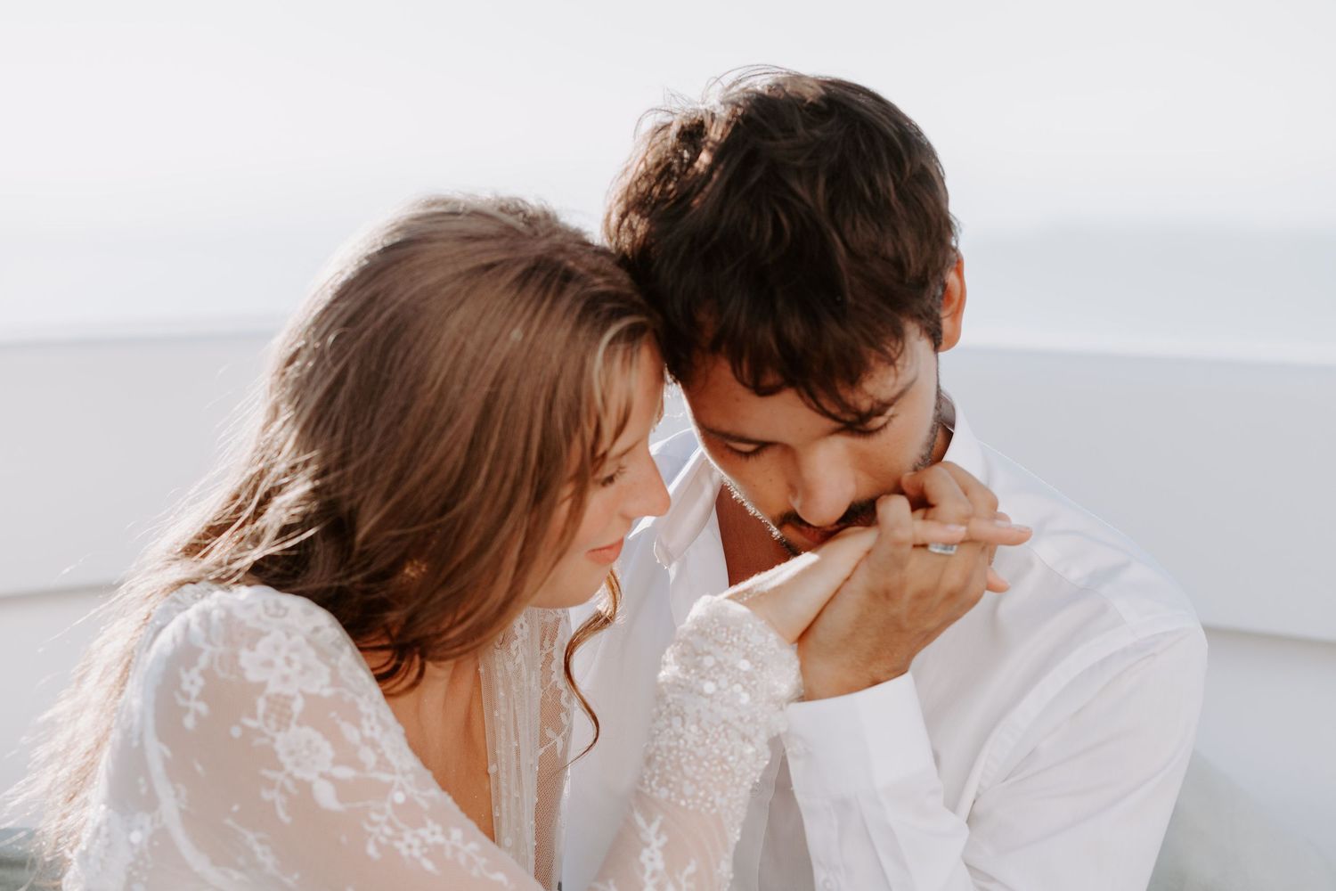 Romantic Santorini sea moment captured in soft, intimate lighting.
