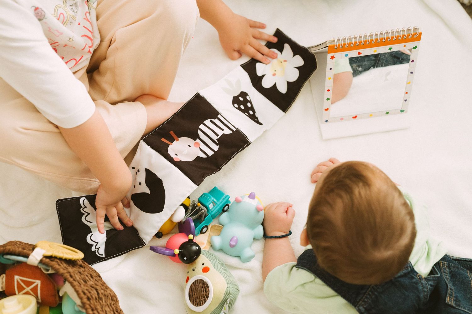 Children engaged in creative play with toys and activities on a white surface.