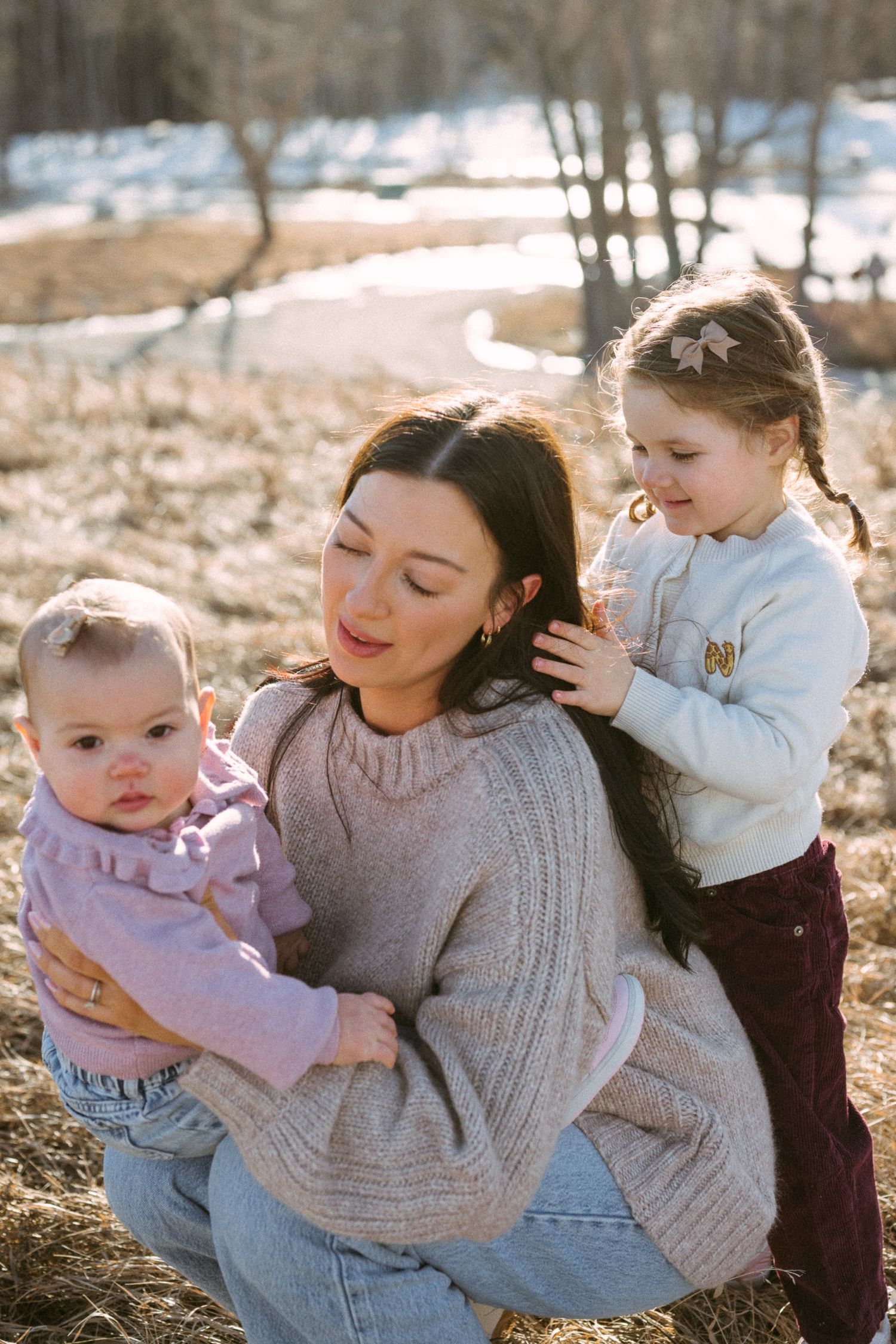 A tender family moment captured in a series of outdoor photos during golden hour lighting.