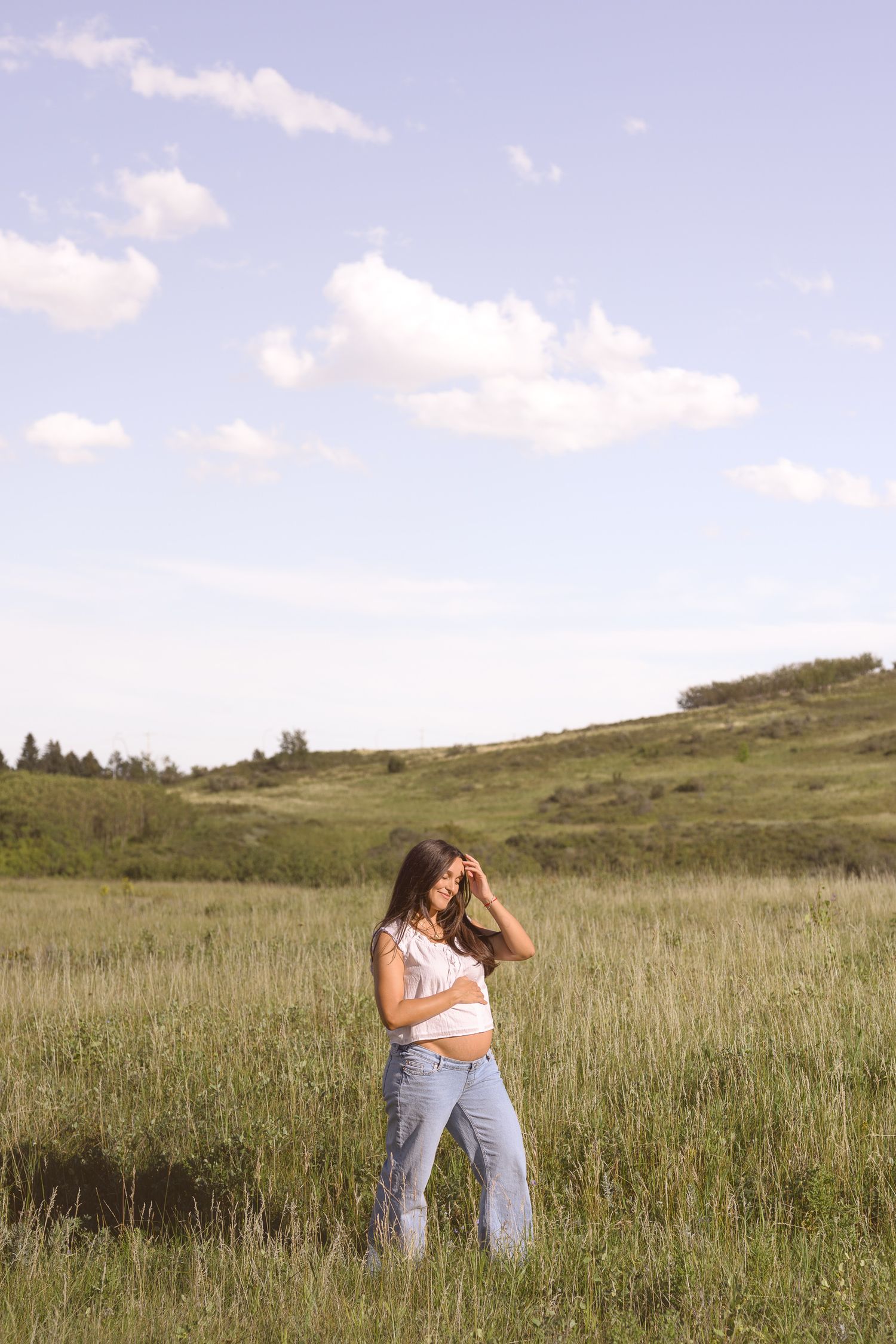 Two people embracing in a sunny wildflower field.